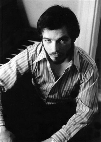 Bruce seated at the piano